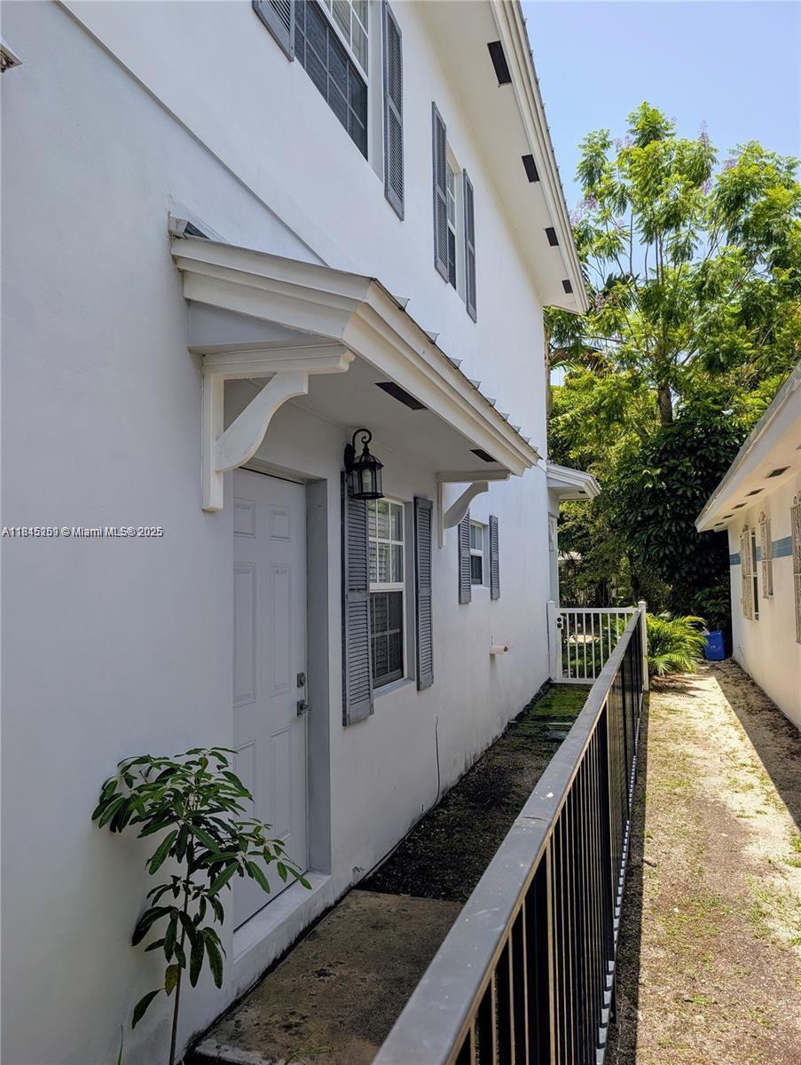 106 Florida Avenue Coral Gables, FL 33133 - Photo 6 of 34 a view of a house with wooden stairs and a table