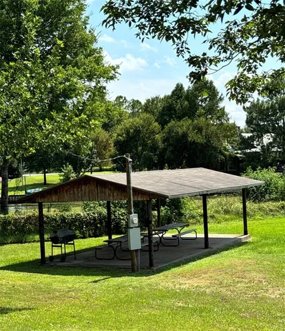 a view of lawn chairs and table under an umbrella