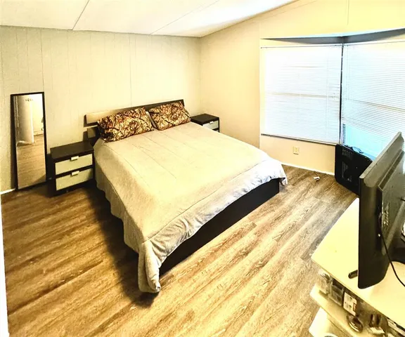 a bed sitting in a bedroom next to a window