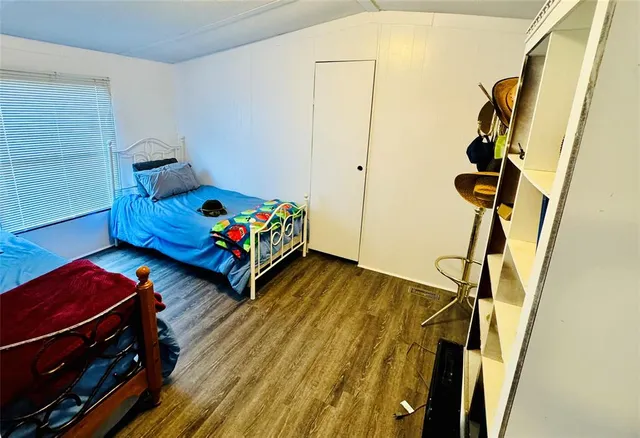 a living room with baby crib furniture and a window