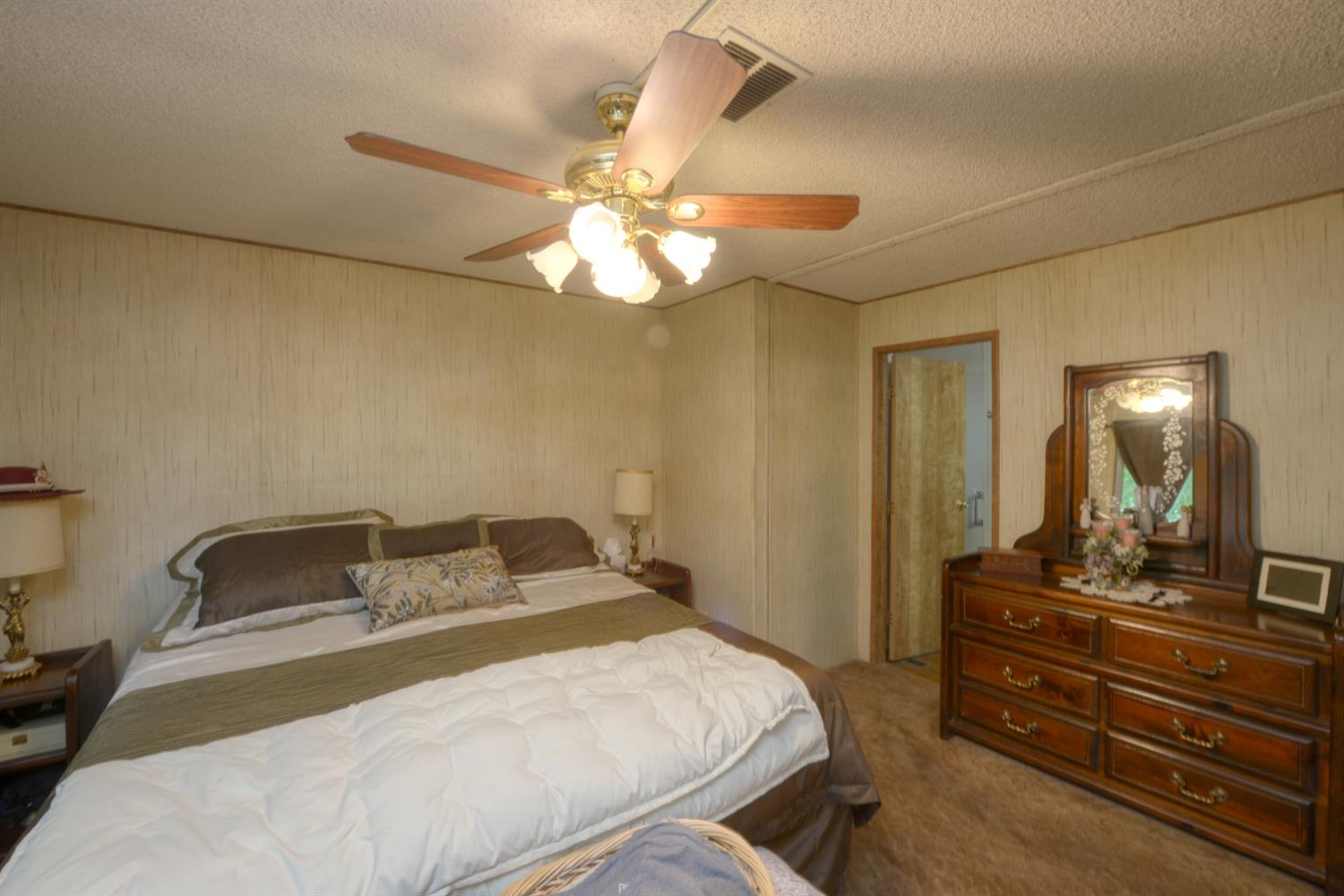 1471 Highway 33 Gustine, CA 95322 - Photo 47 of 57 a bedroom with a bed and a chandelier