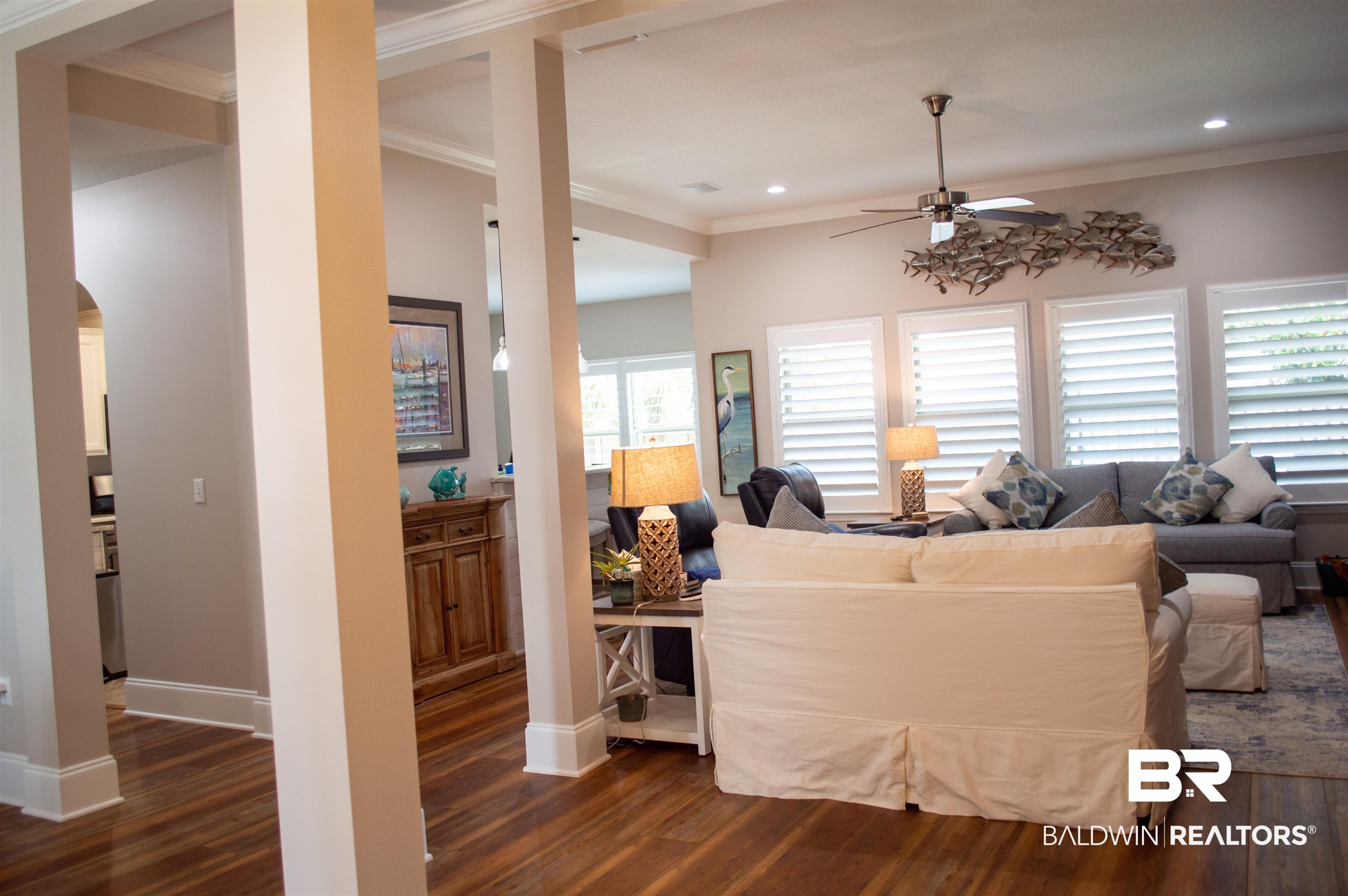 1124 West Orlando Drive Foley, AL 36535 - Photo 6 of 51 Living area with dark wood-style flooring, crown molding, arched walkways, a ceiling fan, and recessed lighting