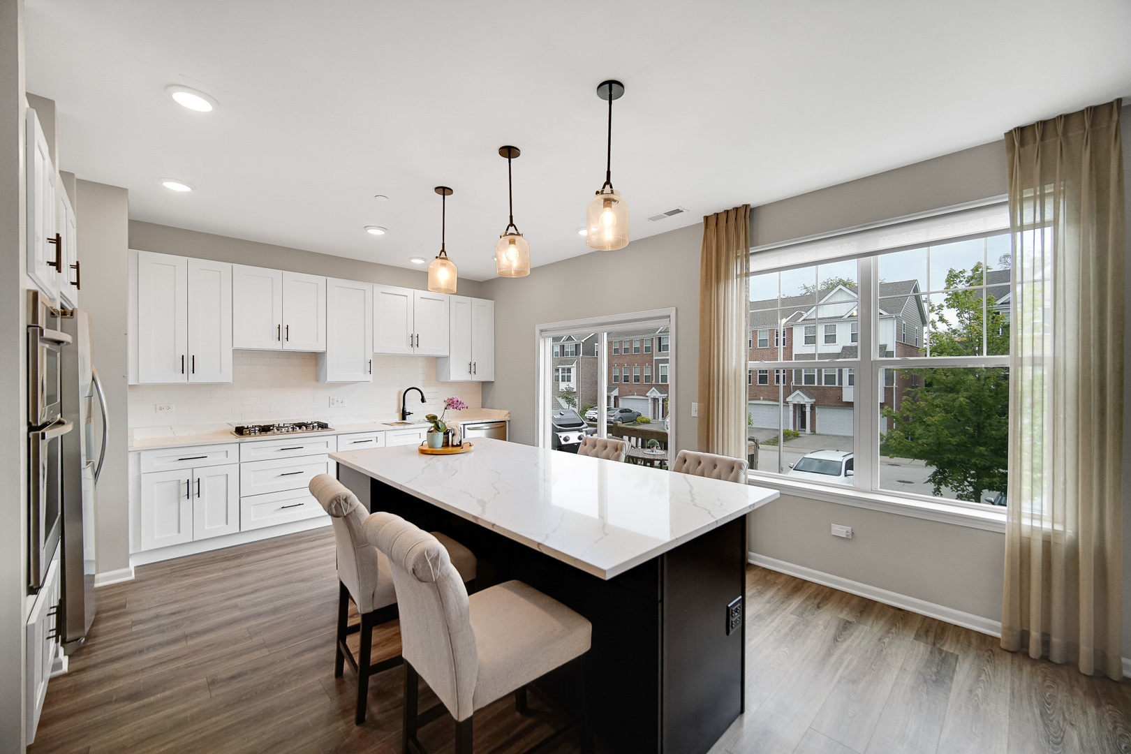 29 Grey Wolf Drive Wheeling, IL 60090 - Photo 2 of 30 a kitchen with a table chairs and wooden floor