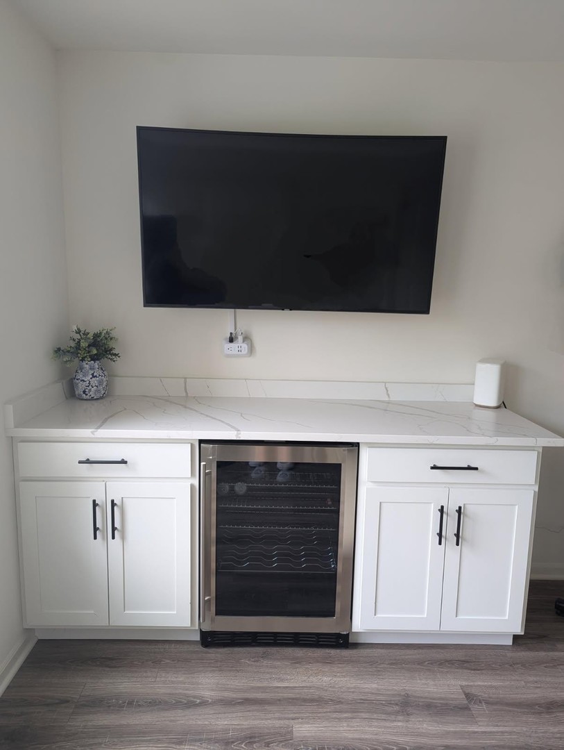 29 Grey Wolf Drive Wheeling, IL 60090 - Photo 21 of 30 a living room with a fireplace and a flat screen tv