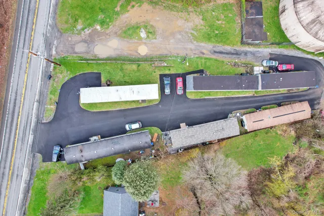 an aerial view of a house with a yard and a large tree