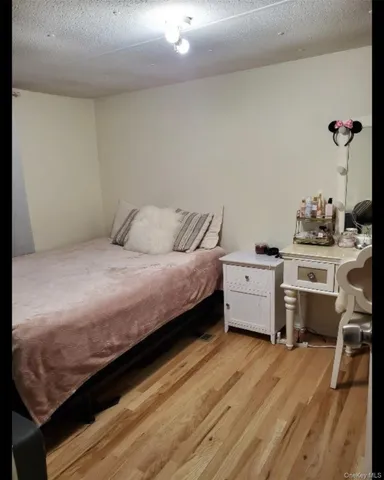 a bedroom with a bed and a desk