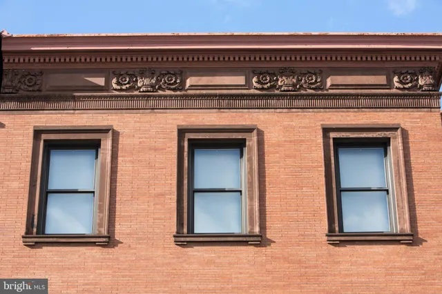 a kitchen with stainless steel appliances granite countertop a stove a sink a microwave a refrigerator and cabinets