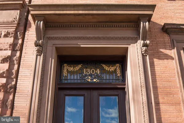 a front view of a building and car parked