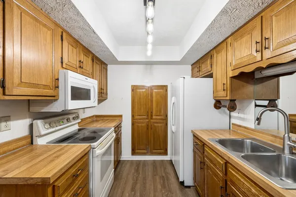 a kitchen that has a sink cabinets counter space and stainless steel appliances