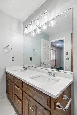 an empty room with windows fireplace and bathroom view