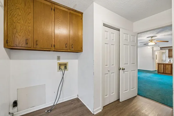 a view of a storage and utility room with wooden floor
