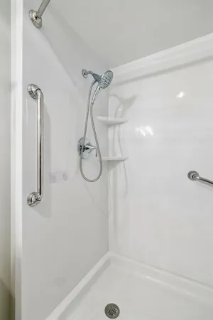 a bathroom with a bath tub with a shower