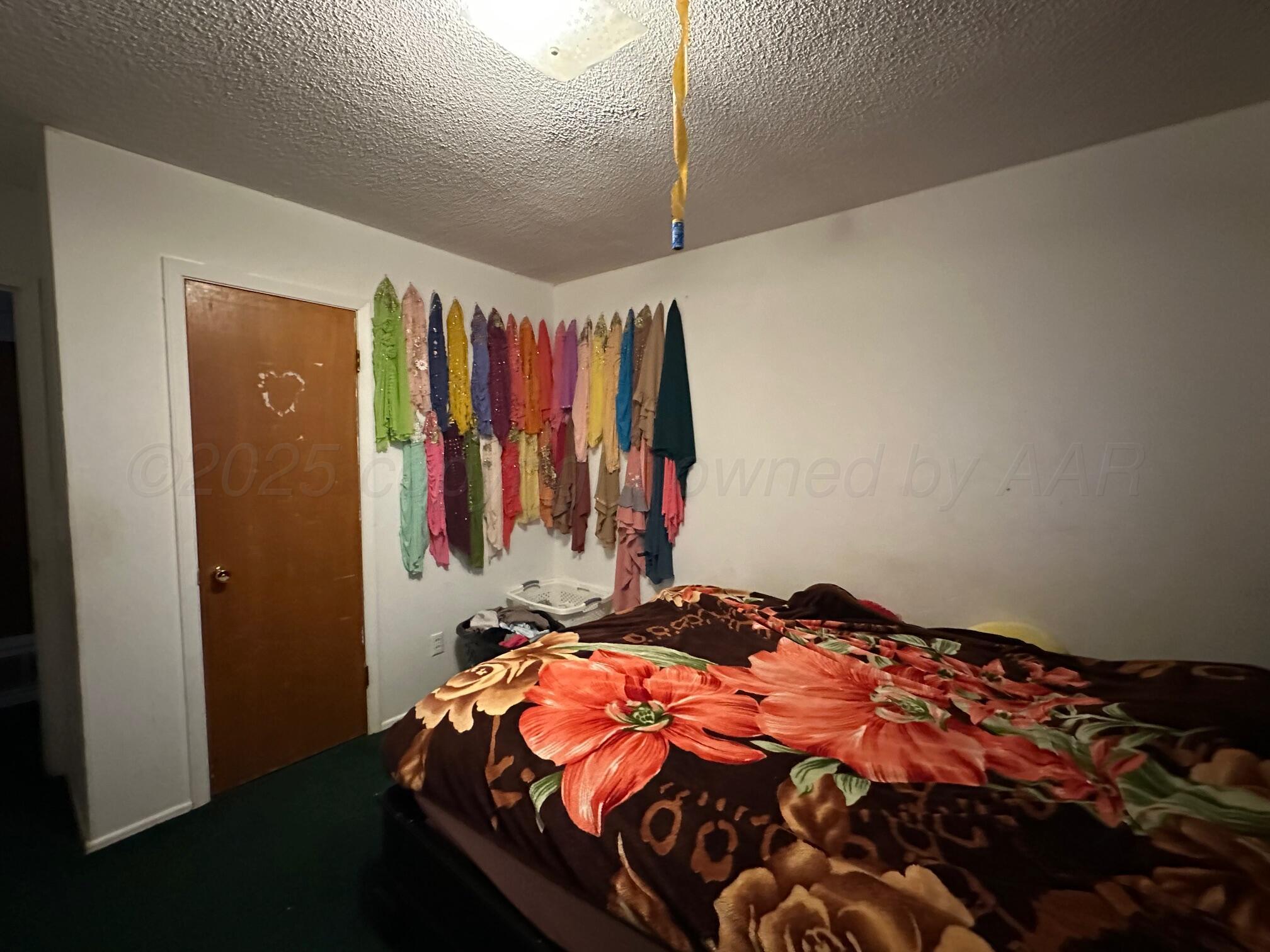 1607 Evergreen Street Amarillo, TX 79107 - Photo 11 of 18 a bedroom with a bed and a closet