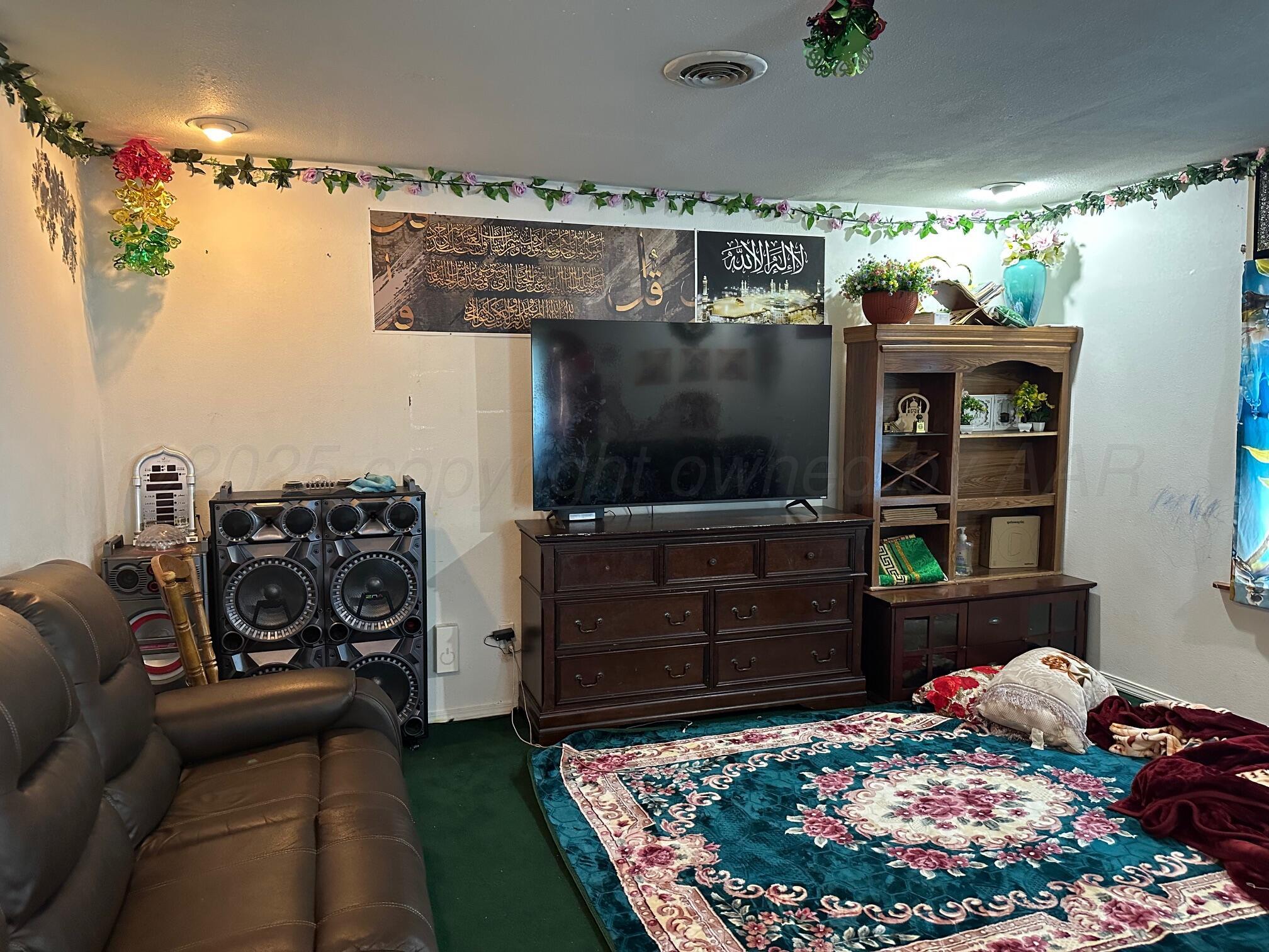 1607 Evergreen Street Amarillo, TX 79107 - Photo 3 of 18 a bed room with a bed and a television