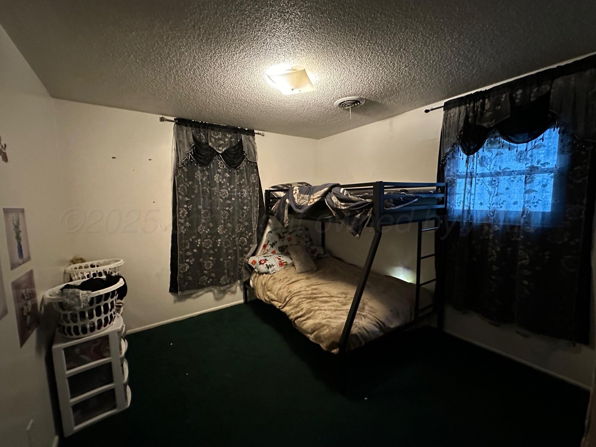 1607 Evergreen Street Amarillo, TX 79107 - Photo 10 of 18 a bedroom with a bed and a closet