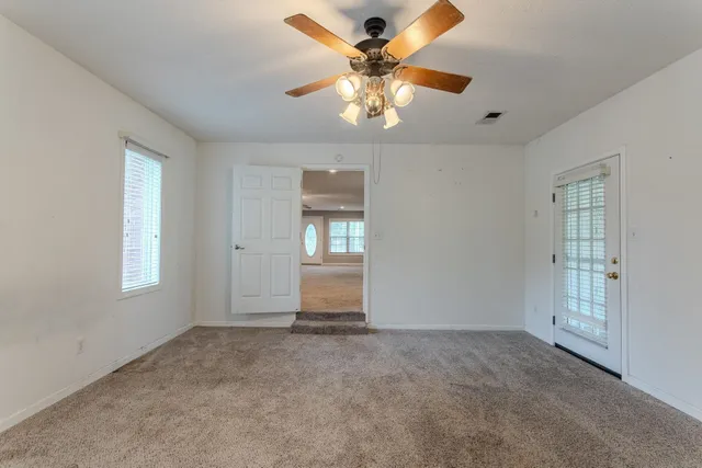 a bathroom with a tub a sink and a mirror