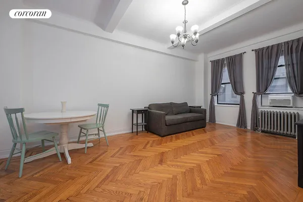 a bedroom with furniture and a chandelier