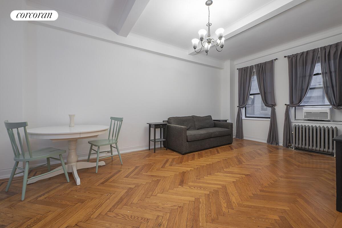 535 West 110th Street, Unit 4A Manhattan, NY 10025 - Photo 2 of 12 a bedroom with furniture and a chandelier