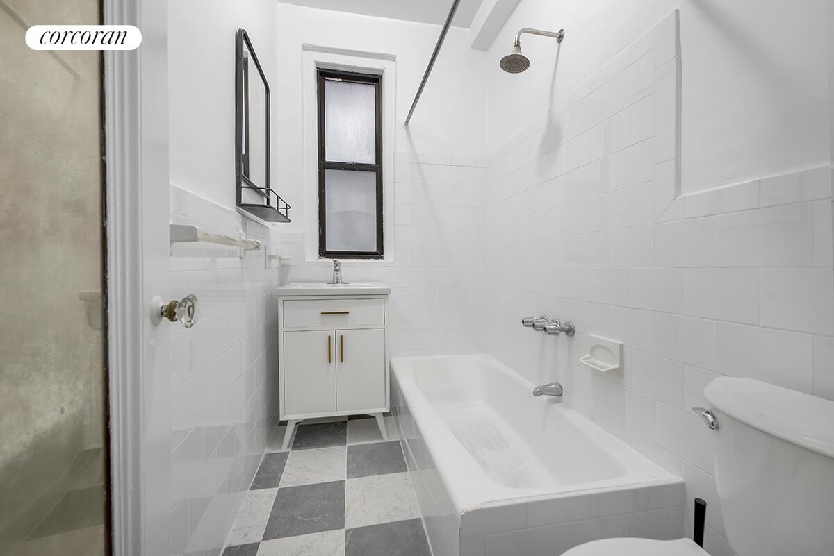 535 West 110th Street, Unit 4A Manhattan, NY 10025 - Photo 6 of 12 a bathroom with a bathtub sink and mirror