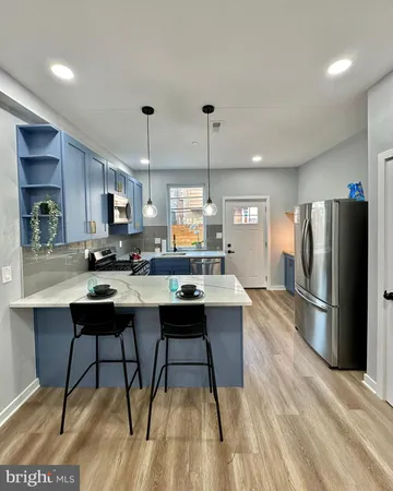 a open kitchen with stainless steel appliances granite countertop a stove a sink dishwasher a refrigerator and a oven