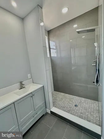 a bathroom with a sink and shower