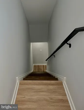 a view of a room with wooden floor and white doors
