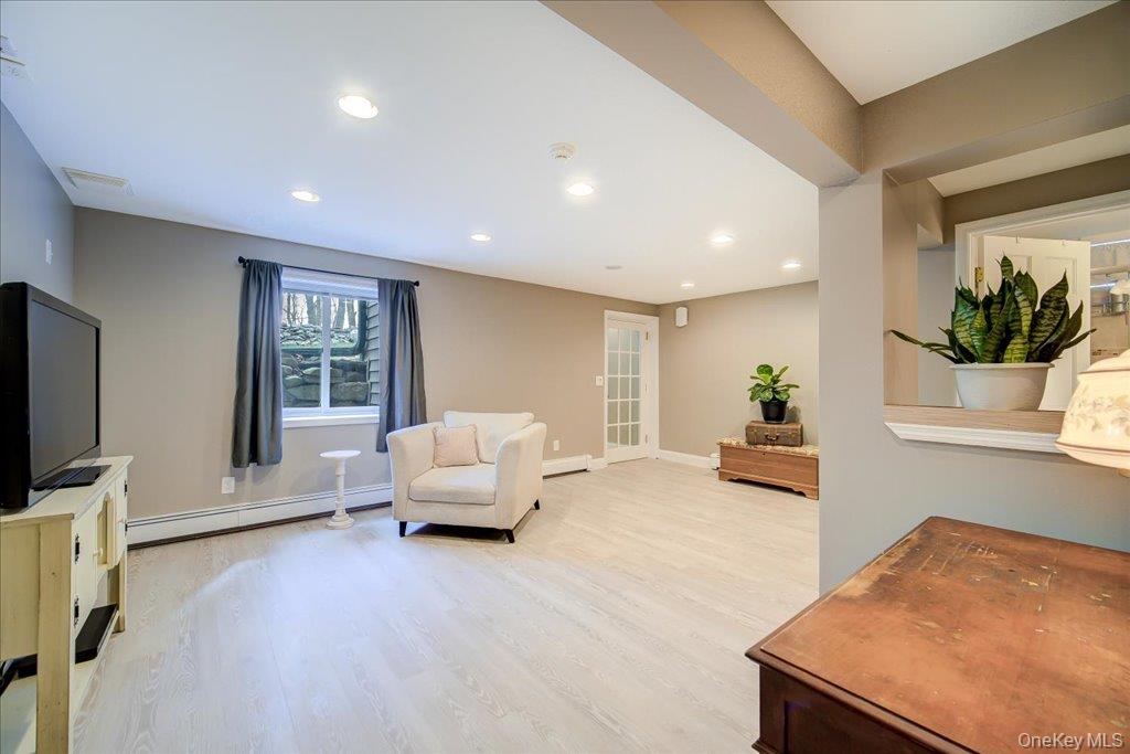 157 Brewer Road Newburgh, NY 12550 - Photo 31 of 50 Living area featuring light-toned flooring, recessed lighting, and a window with a view of greenery