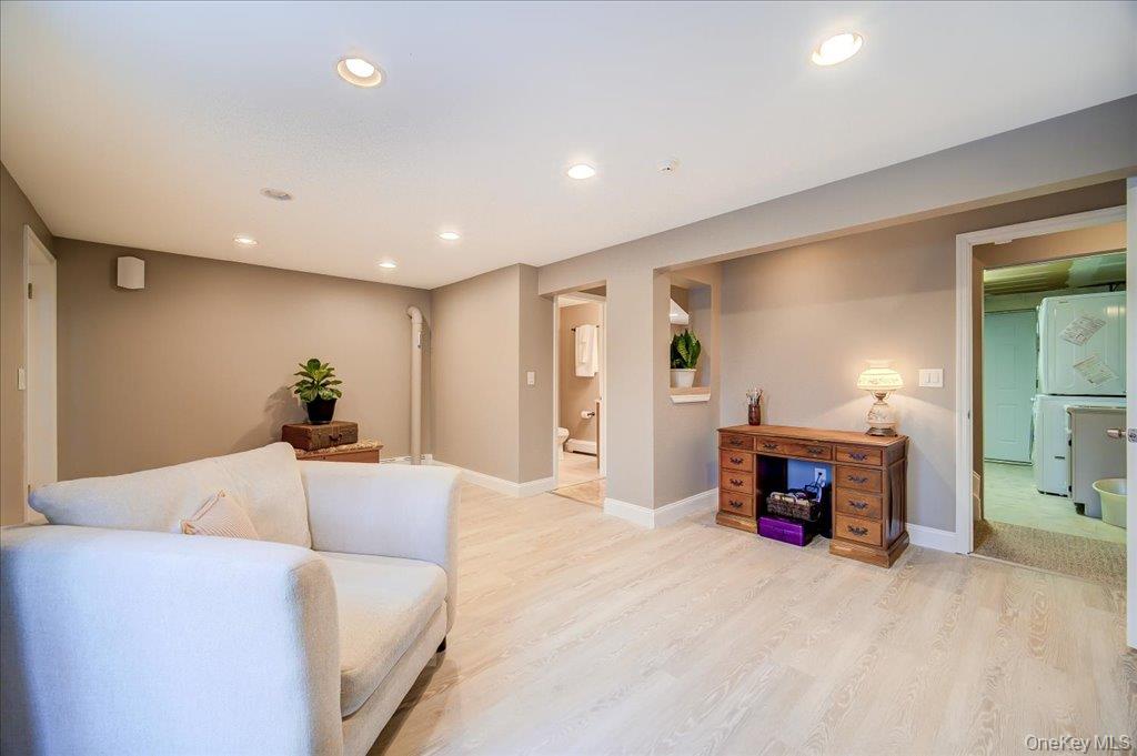 157 Brewer Road Newburgh, NY 12550 - Photo 32 of 50 This versatile room features light-toned flooring, recessed lighting, and access to a separate area containing a washing machine and dryer