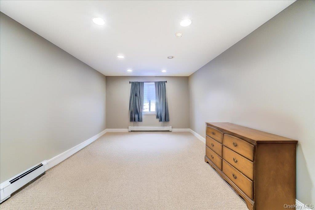 157 Brewer Road Newburgh, NY 12550 - Photo 36 of 50 This room features recessed lighting, light-colored carpeting, and a window with curtains