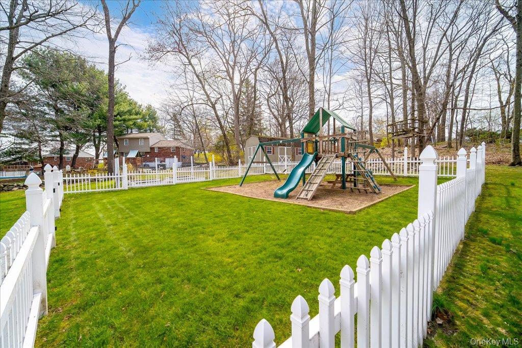 157 Brewer Road Newburgh, NY 12550 - Photo 43 of 50 The property features a spacious lawn area, enclosed by a white picket fence
