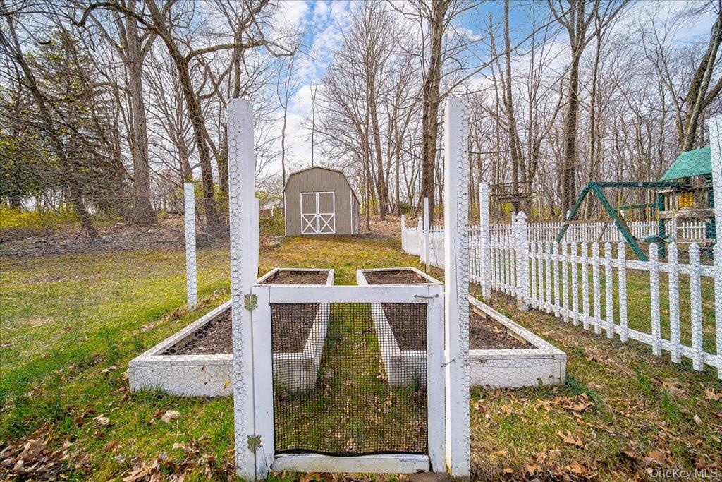 157 Brewer Road Newburgh, NY 12550 - Photo 44 of 50 The property includes a fenced garden area with two raised beds and a separate storage shed