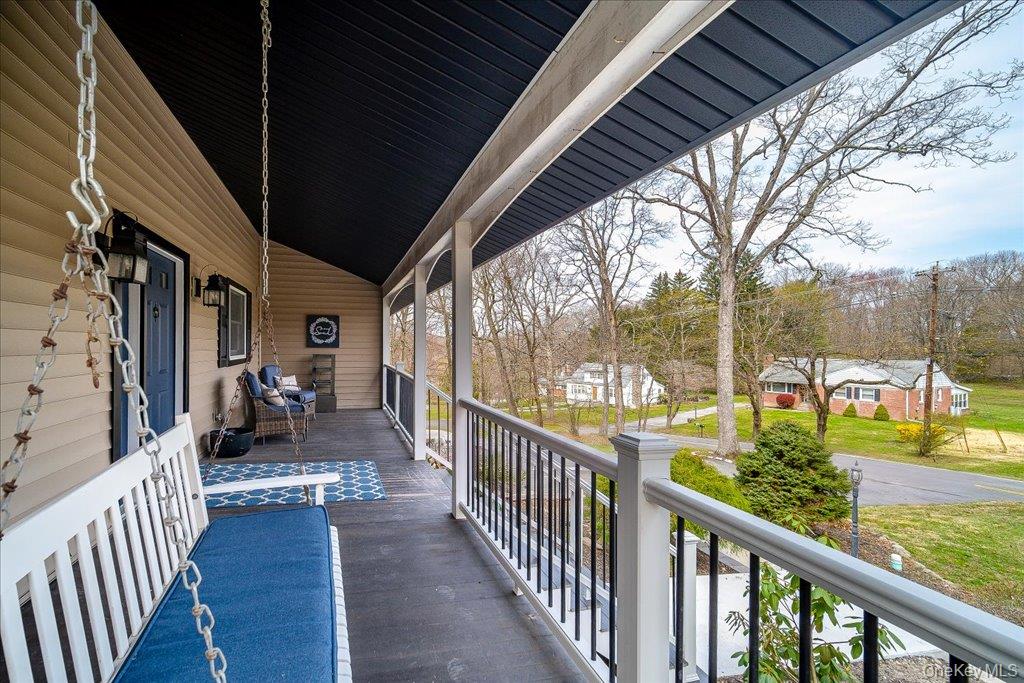 157 Brewer Road Newburgh, NY 12550 - Photo 5 of 50 Inviting covered front porch with a porch swing, siding exterior, and a railing overlooking the surrounding landscape