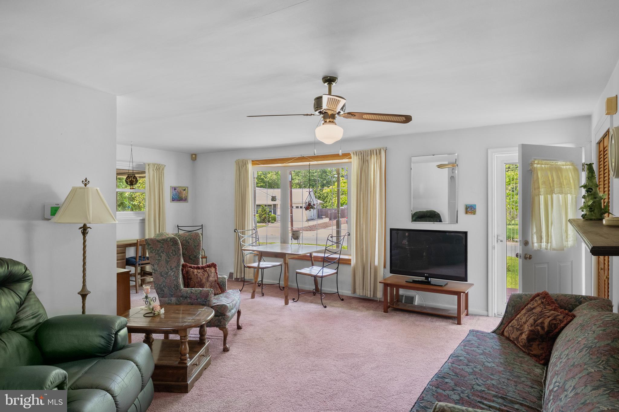225 Buckner Avenue Haddonfield, NJ 08033 - Photo 5 of 24 a living room with furniture a flat screen tv and a window