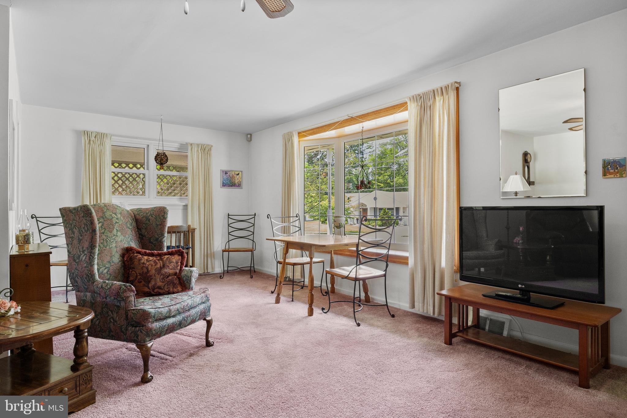 225 Buckner Avenue Haddonfield, NJ 08033 - Photo 6 of 24 a living room with furniture a flat screen tv and a fireplace