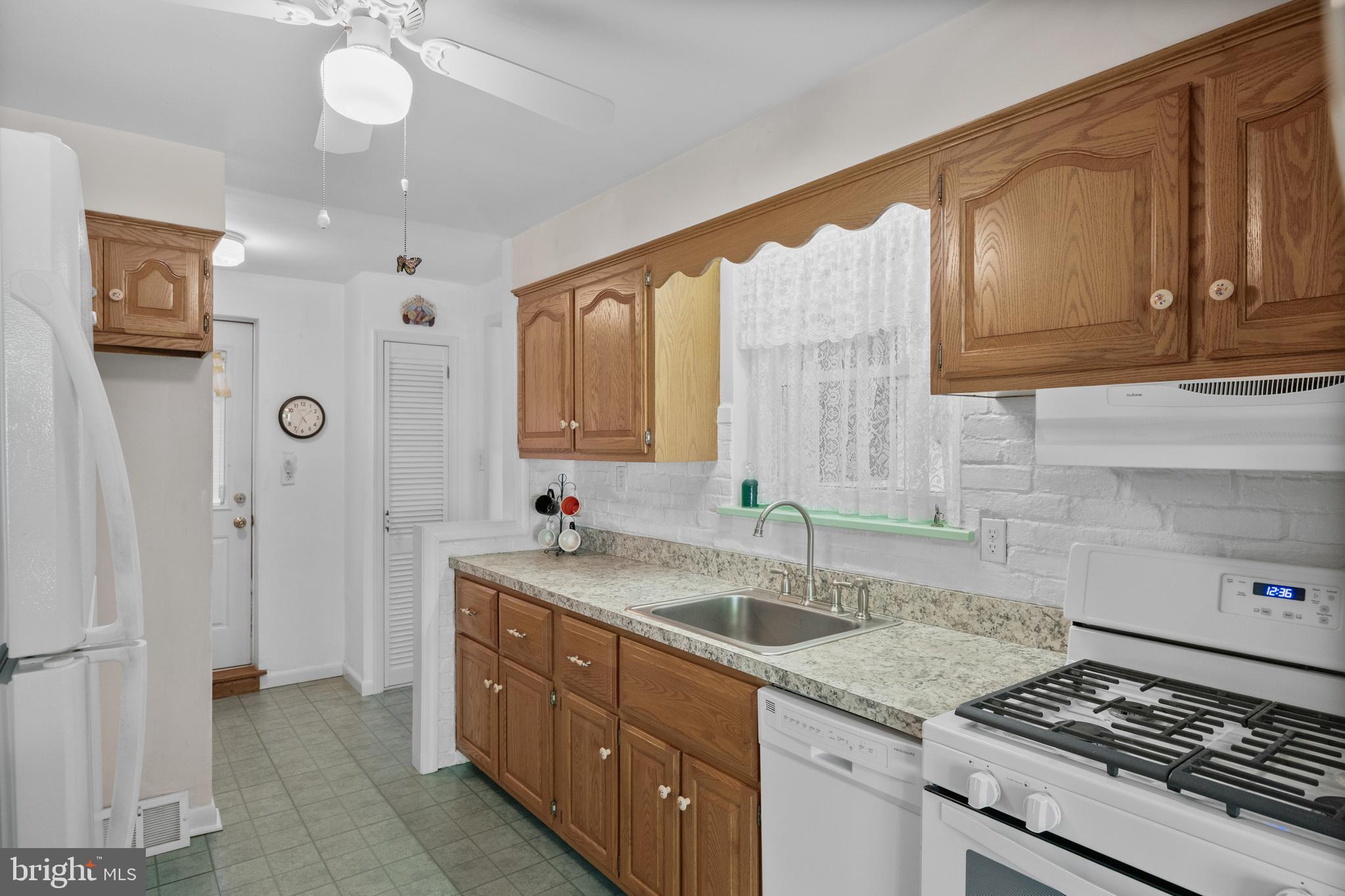 225 Buckner Avenue Haddonfield, NJ 08033 - Photo 8 of 24 a kitchen with a sink stove and cabinets