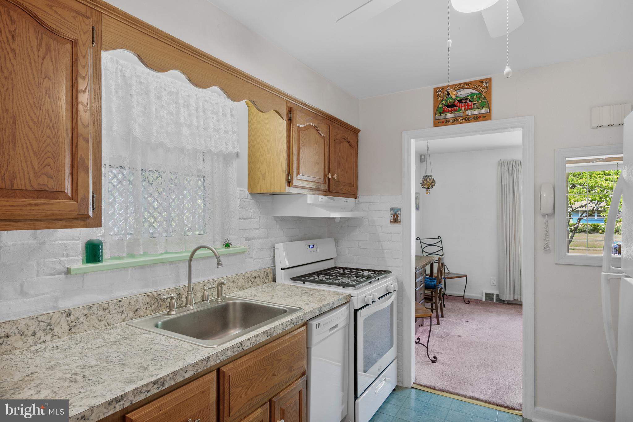 225 Buckner Avenue Haddonfield, NJ 08033 - Photo 9 of 24 a kitchen that has a sink and a stove in it