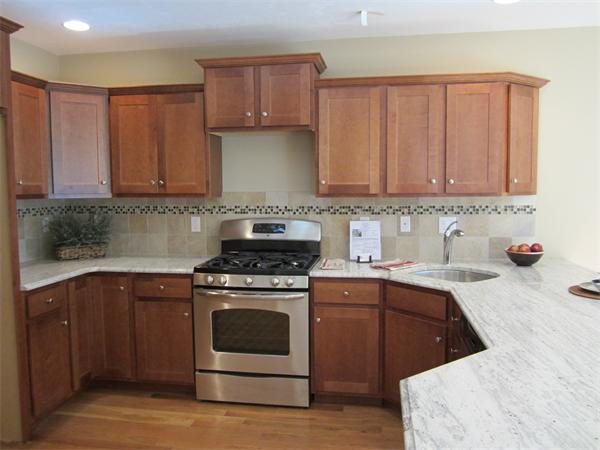 121 Dudley Road, Unit 121 Berlin, MA 01503 - Photo 8 of 16 a kitchen with a sink stove top oven and cabinets