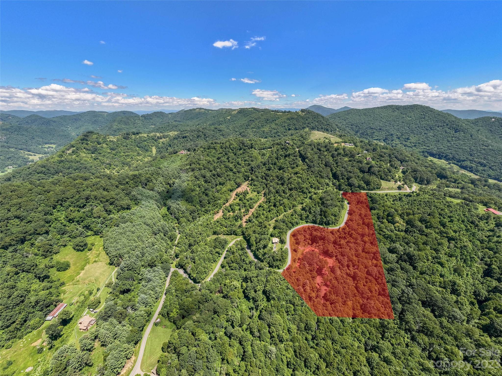 0 Runaway Ridge Clyde, NC 28721 - Photo 22 of 26 a view of a lush green hillside and a mountain