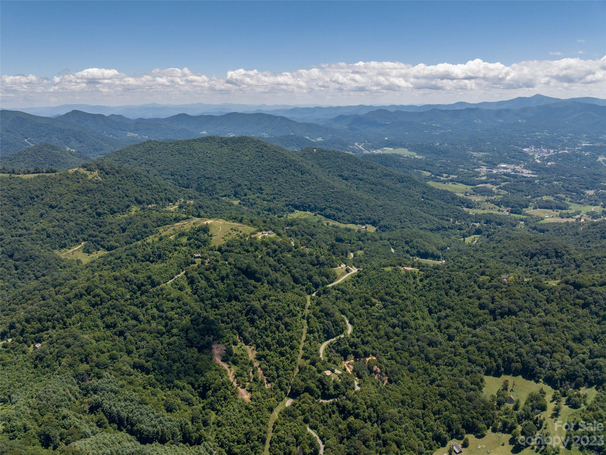 0 Runaway Ridge Clyde, NC 28721 - Photo 5 of 26 an aerial view of houses covered in trees