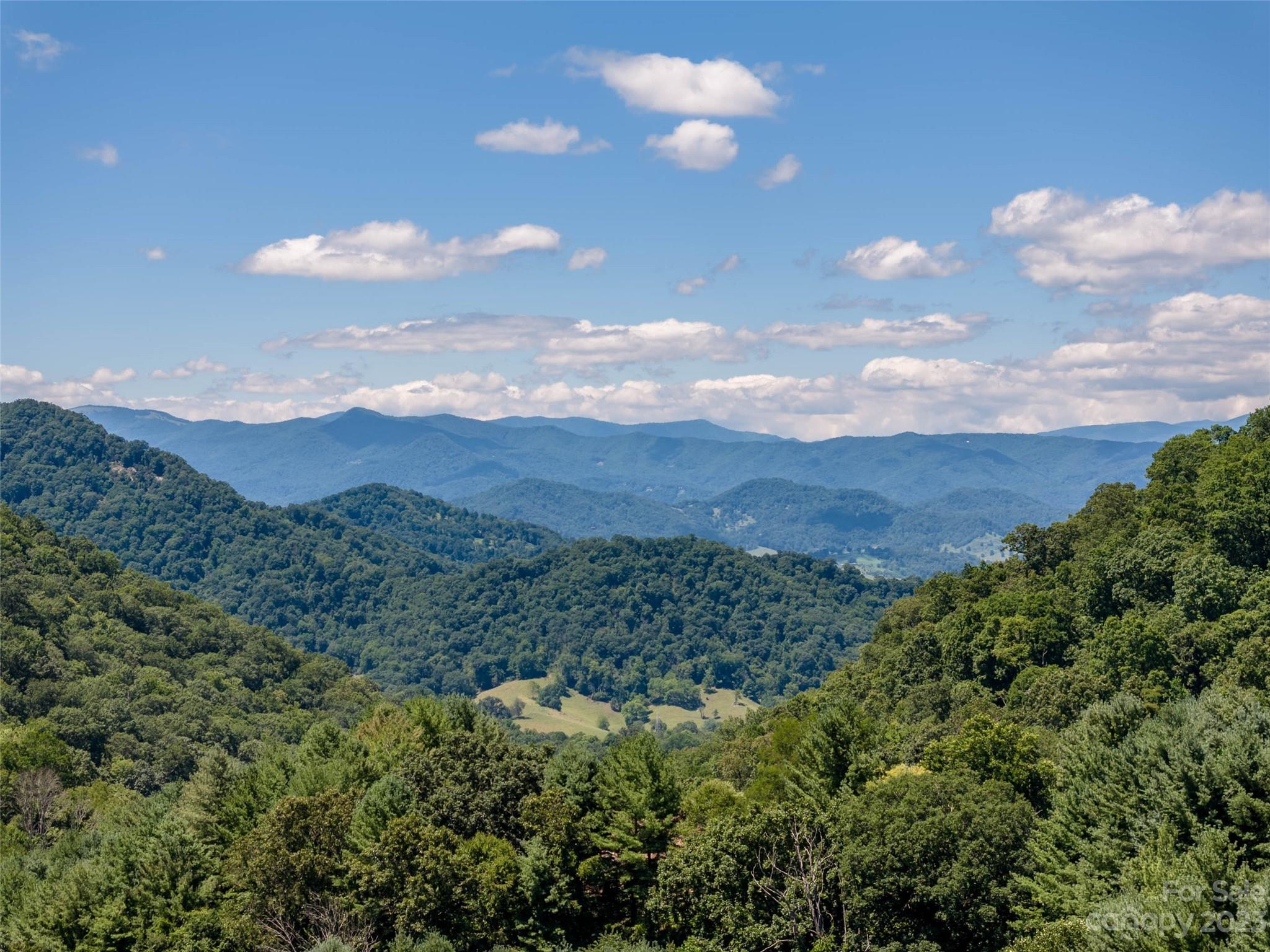 0 Runaway Ridge Clyde, NC 28721 - Photo 8 of 26 a view of a city with lush green forest