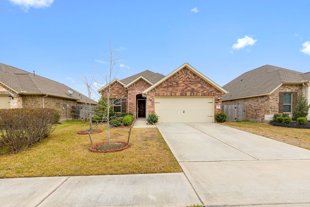 2666 Cedar Path Lane Conroe, TX 77385 - Photo 2 of 22 a front view of a house with yard