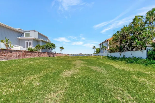 a view of yard with swimming pool and green space