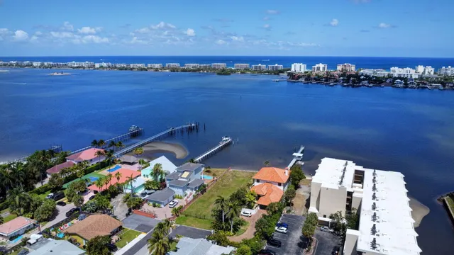an aerial view of residential houses with outdoor space and parking