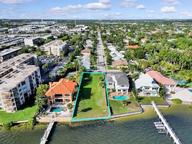 an aerial view of residential houses with outdoor space and parking