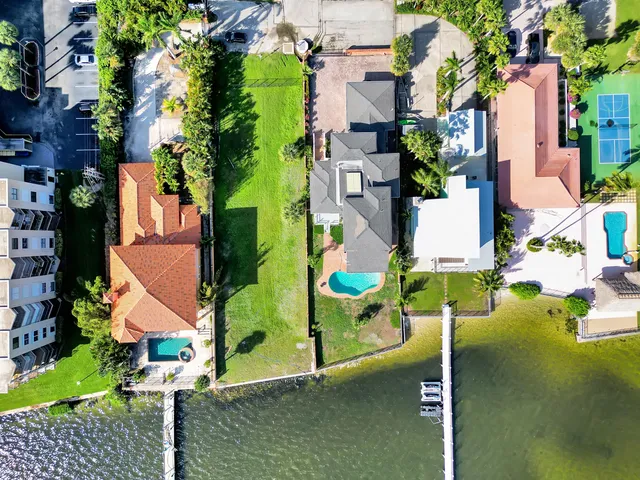 an aerial view of residential houses with outdoor space and street view