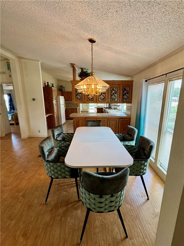 25051 Lake Shore Drive Mathis, TX 78368 - Photo 18 of 40 a view of a dining room with furniture window and wooden floor
