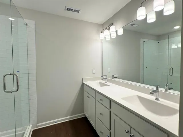 a bathroom with a double vanity sink and a mirror