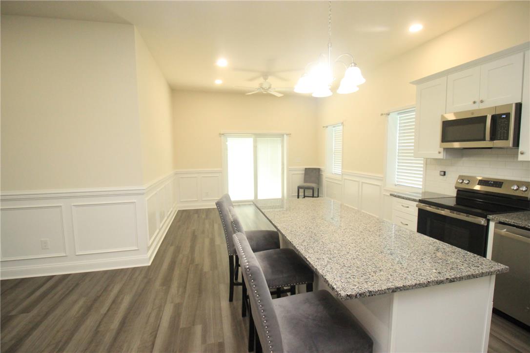 3083 Penn Allen Road, Unit B Nazareth, PA 18064 - Photo 12 of 21 A well-appointed kitchen and dining area features granite countertops and modern appliances, blending seamlessly with an open-concept living space.