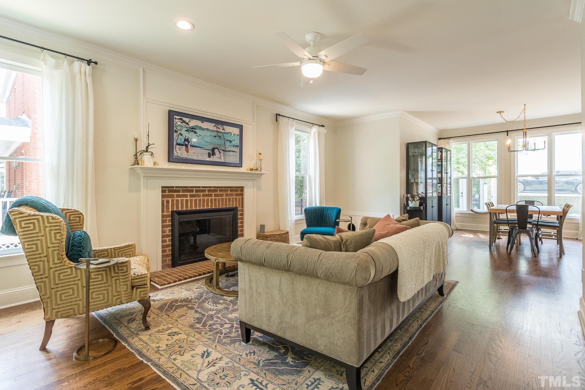 509 Watauga Street Raleigh, NC 27604 - Photo 6 of 26 a living room with furniture a fireplace and a table