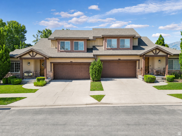 1429 Chateau Ridge Way Sandy, UT 84092 - Photo 22 of 22 Duplex-style property featuring a neutral stucco and stone facade with wood-look garage doors